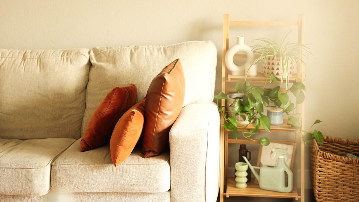a white couch with two pillows on it